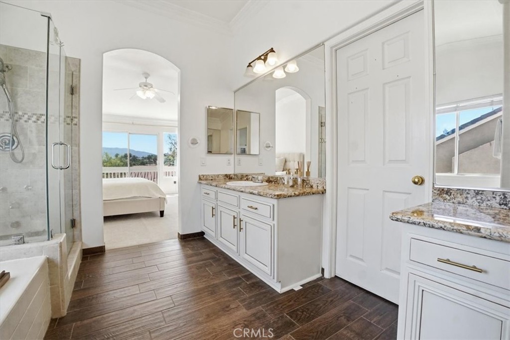 768 Ochee Circle Corona, CA 92879 - Photo 50 of 75 a bathroom with a granite countertop sink and a mirror