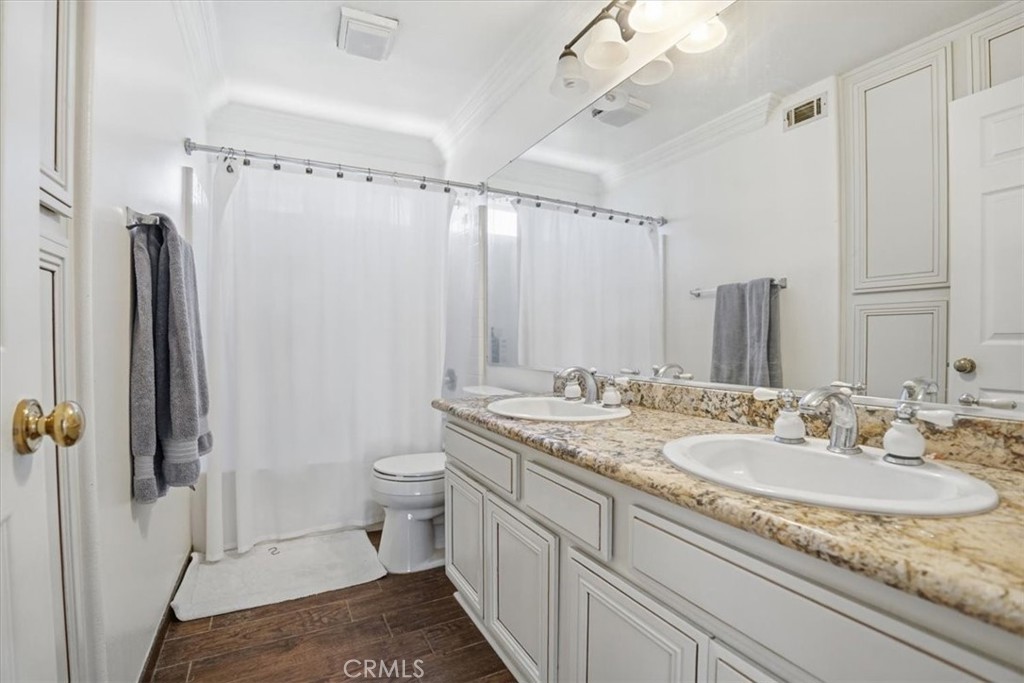 768 Ochee Circle Corona, CA 92879 - Photo 51 of 75 a bathroom with a granite countertop sink toilet and shower