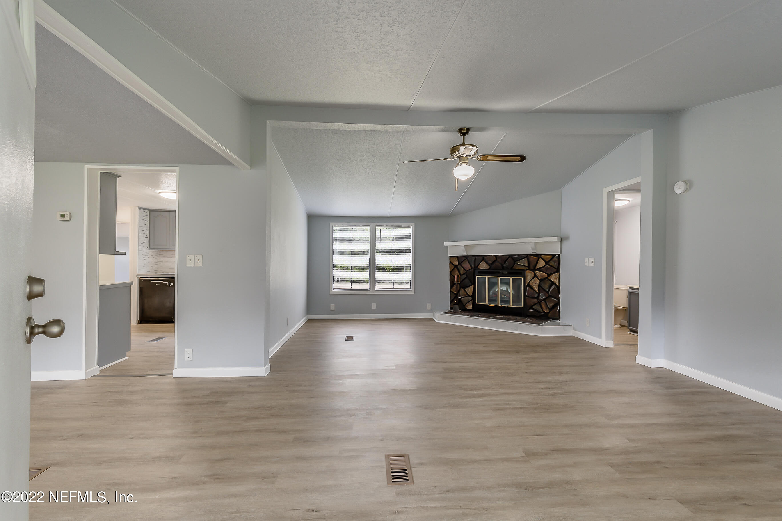 54360 Church Road Callahan, FL 32011 - Photo 12 of 37 wooden floor in an empty room with a fireplace