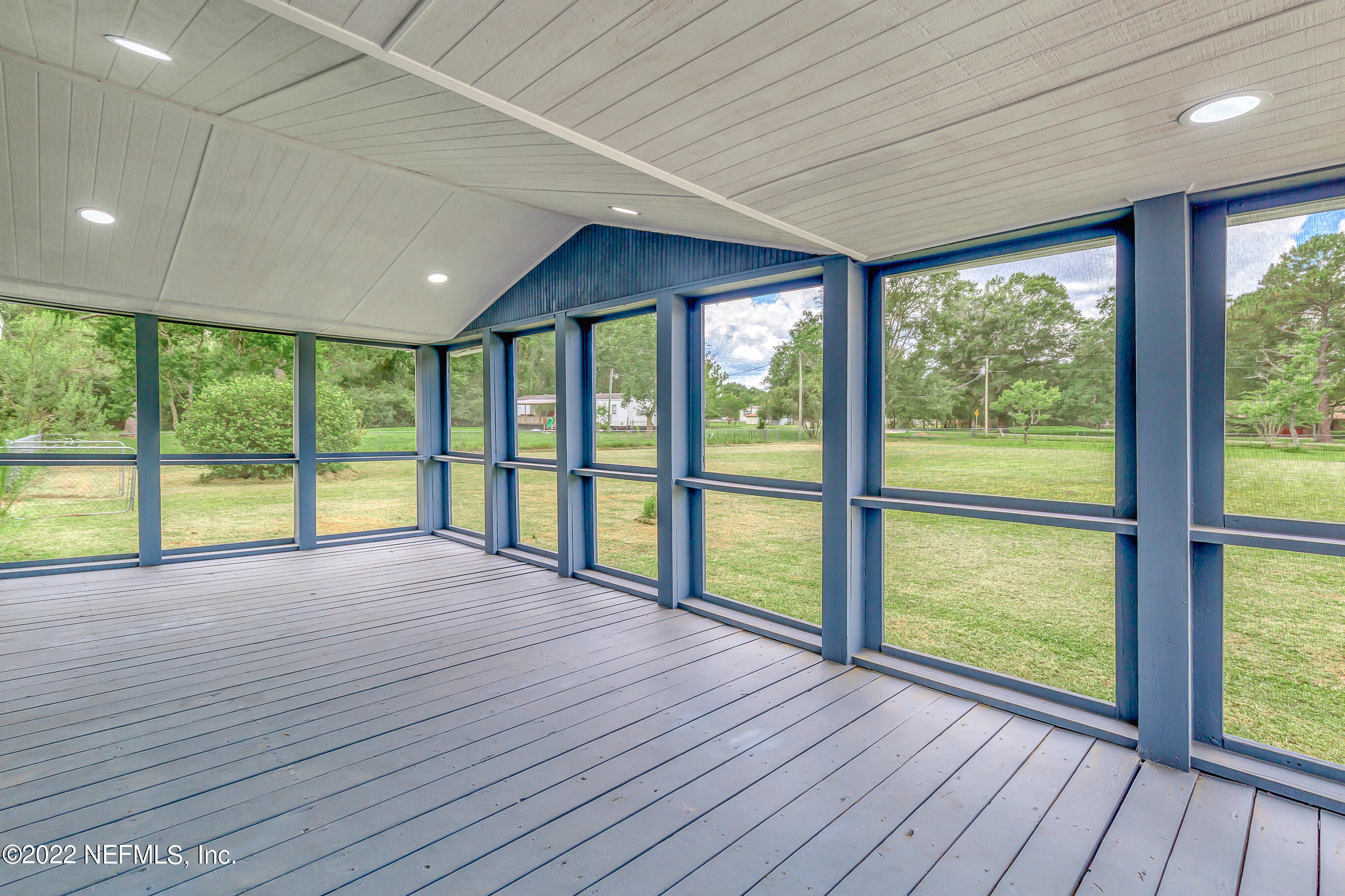54360 Church Road Callahan, FL 32011 - Photo 18 of 37 a view of an empty room with wooden floor and doors