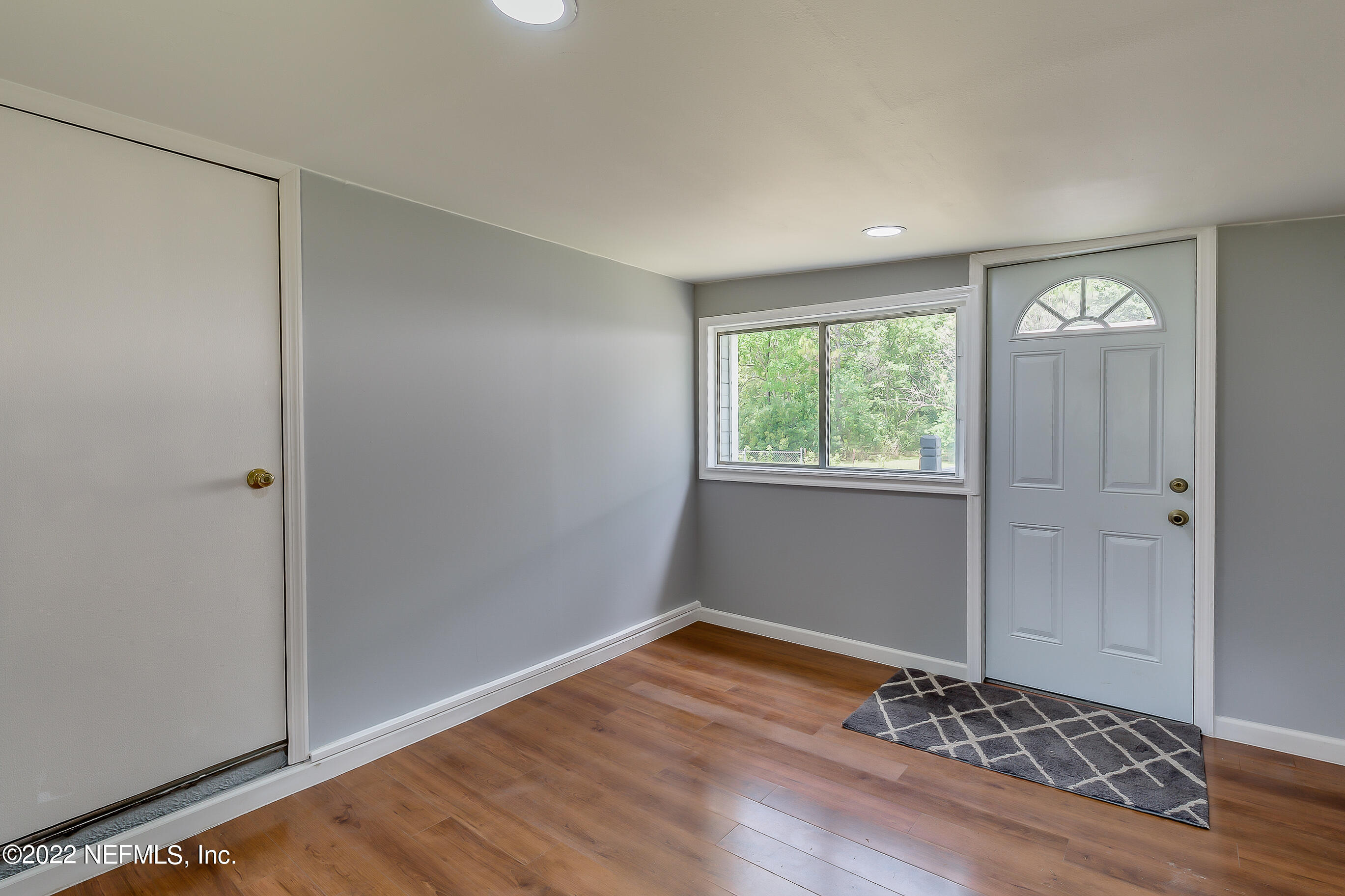 54360 Church Road Callahan, FL 32011 - Photo 24 of 37 a view of an empty room with wooden floor and a window
