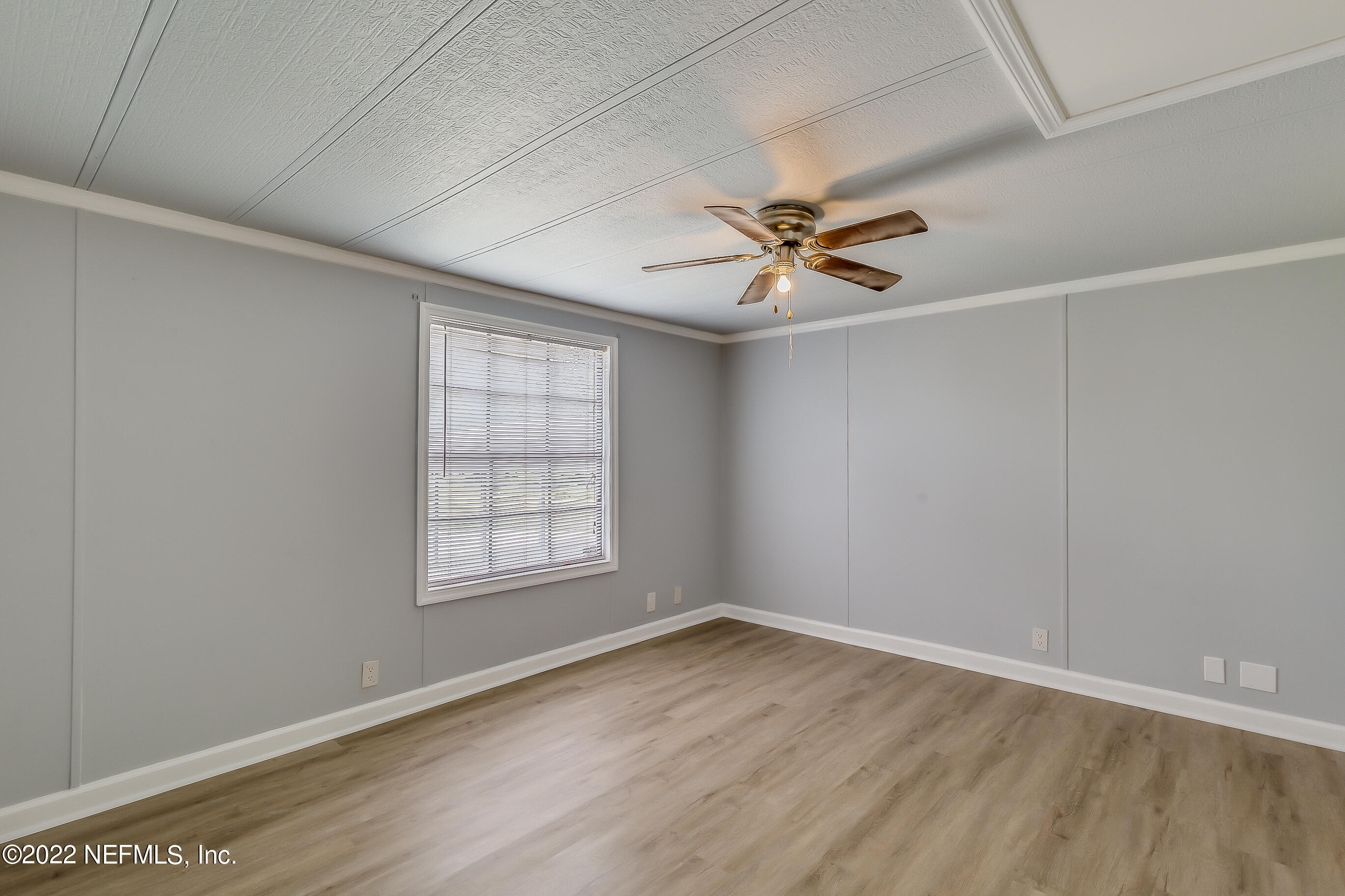 54360 Church Road Callahan, FL 32011 - Photo 25 of 37 an empty room with wooden floor and window