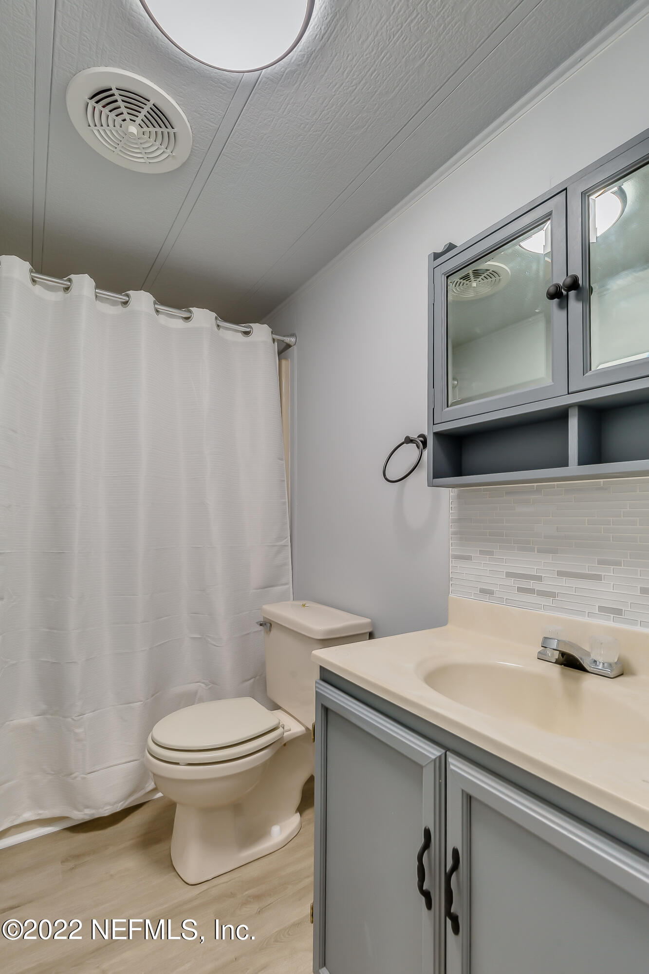 54360 Church Road Callahan, FL 32011 - Photo 29 of 37 a bathroom with a sink a toilet and a mirror
