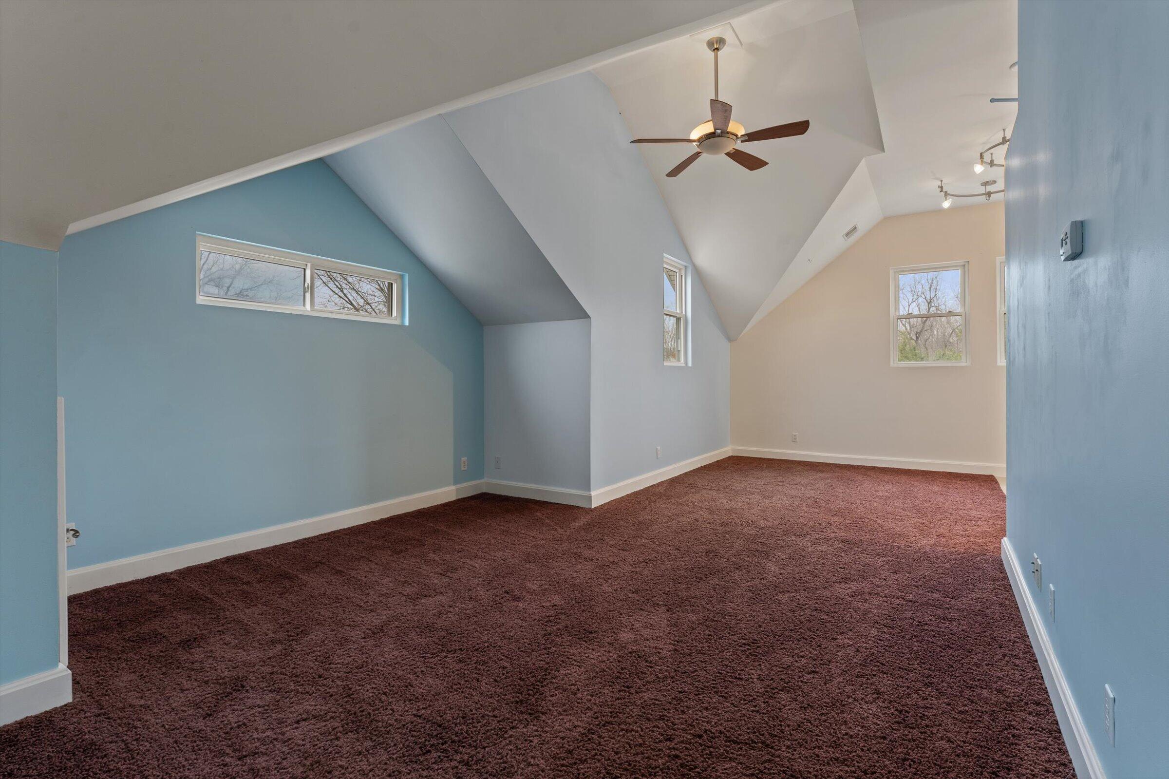 7692 North Emery Road Rolling Prairie, IN 46371 - Photo 46 of 69 an empty room that has a ceiling fan and a window