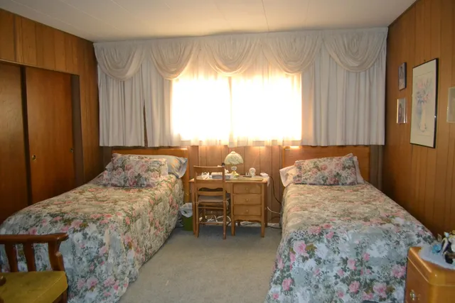 a bedroom with a bed and lamp