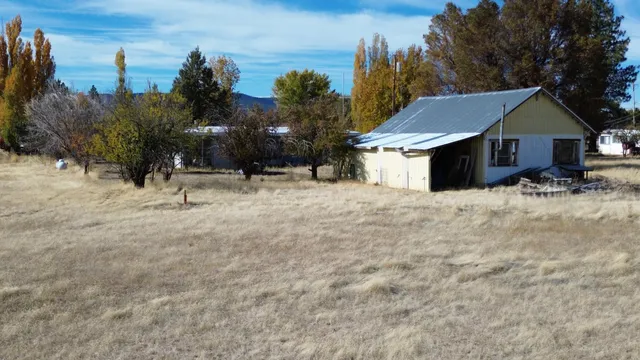a view of a house with snow on the background