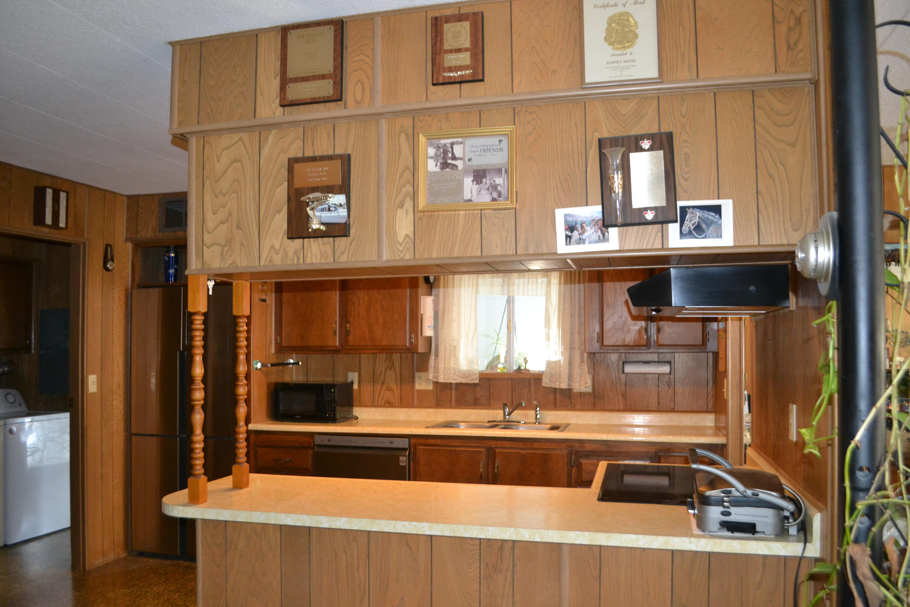 309 Punkin Center Road Bieber, CA 96009 - Photo 8 of 34 a kitchen with a sink and a refrigerator