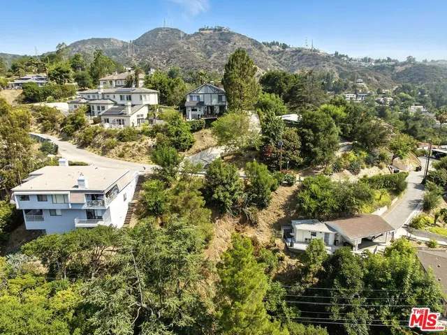 an aerial view of a house with yard and parking