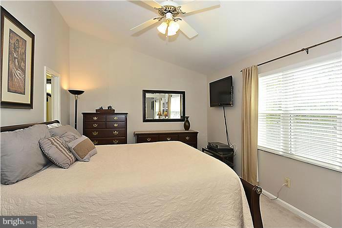 127 Kinsman View Circle Silver Spring, MD 20901 - Photo 12 of 21 a bedroom with a large bed and a window