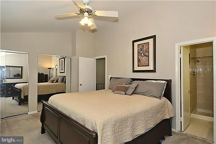 127 Kinsman View Circle Silver Spring, MD 20901 - Photo 13 of 21 a bedroom with a bed and a chandelier
