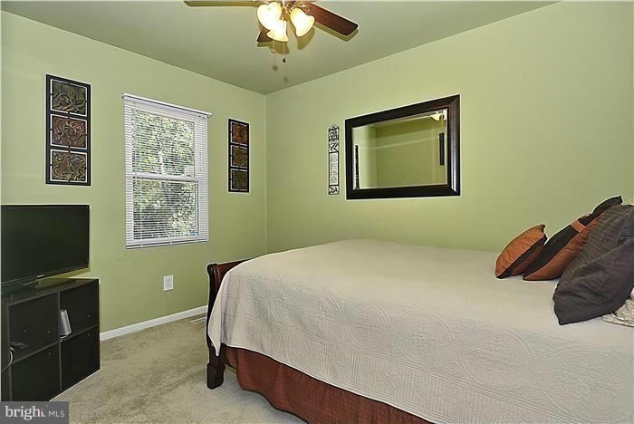 127 Kinsman View Circle Silver Spring, MD 20901 - Photo 15 of 21 a bedroom with a bed and a window