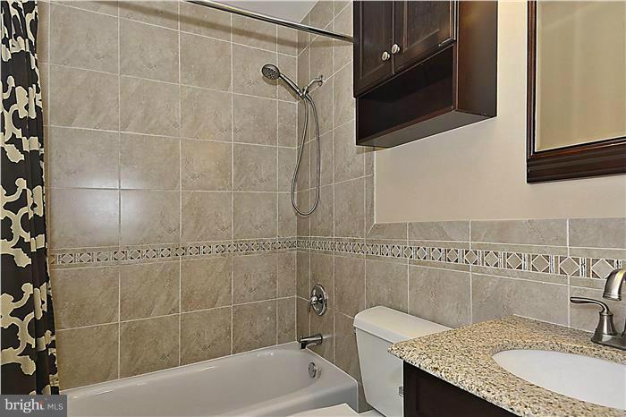 127 Kinsman View Circle Silver Spring, MD 20901 - Photo 17 of 21 a bathroom with a granite countertop sink a mirror and bathtub