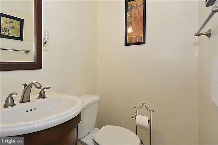 127 Kinsman View Circle Silver Spring, MD 20901 - Photo 20 of 21 a bathroom with a toilet a sink and mirror