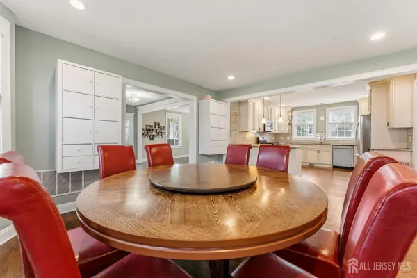a living room with dining room and wooden floor
