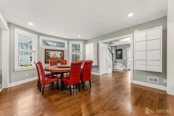 a dining room with furniture and wooden floor