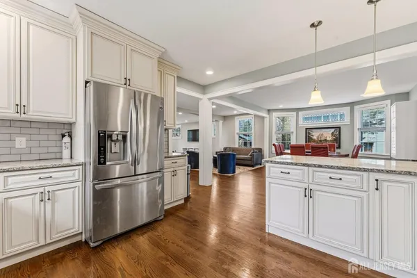 a kitchen with sink refrigerator and cabinets