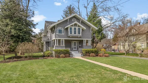 a front view of a house with a yard table and chairs