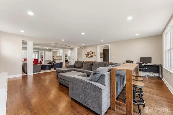 a living room with furniture and a wooden floor