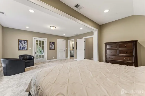 a bathroom with a double vanity sink a mirror and a bathtub