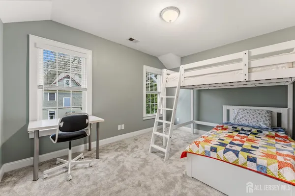 a bathroom with a granite countertop sink a large mirror and a window