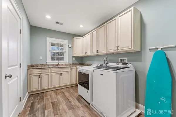 a bedroom with bed lamp and a large window with garden view