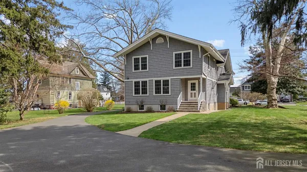 an aerial view of residential houses with outdoor space and swimming pool