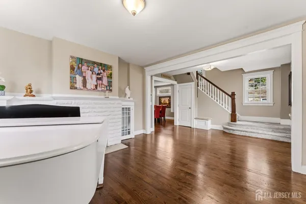 a hallway with wooden floor fireplace and furniture