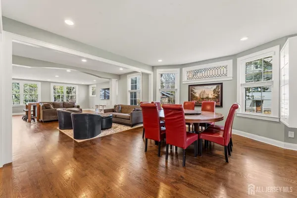 a view of dining room and livingroom with lots of furniture and wooden floor