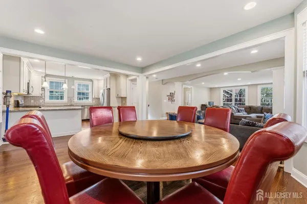 a dining room with furniture a wooden floor and chandelier