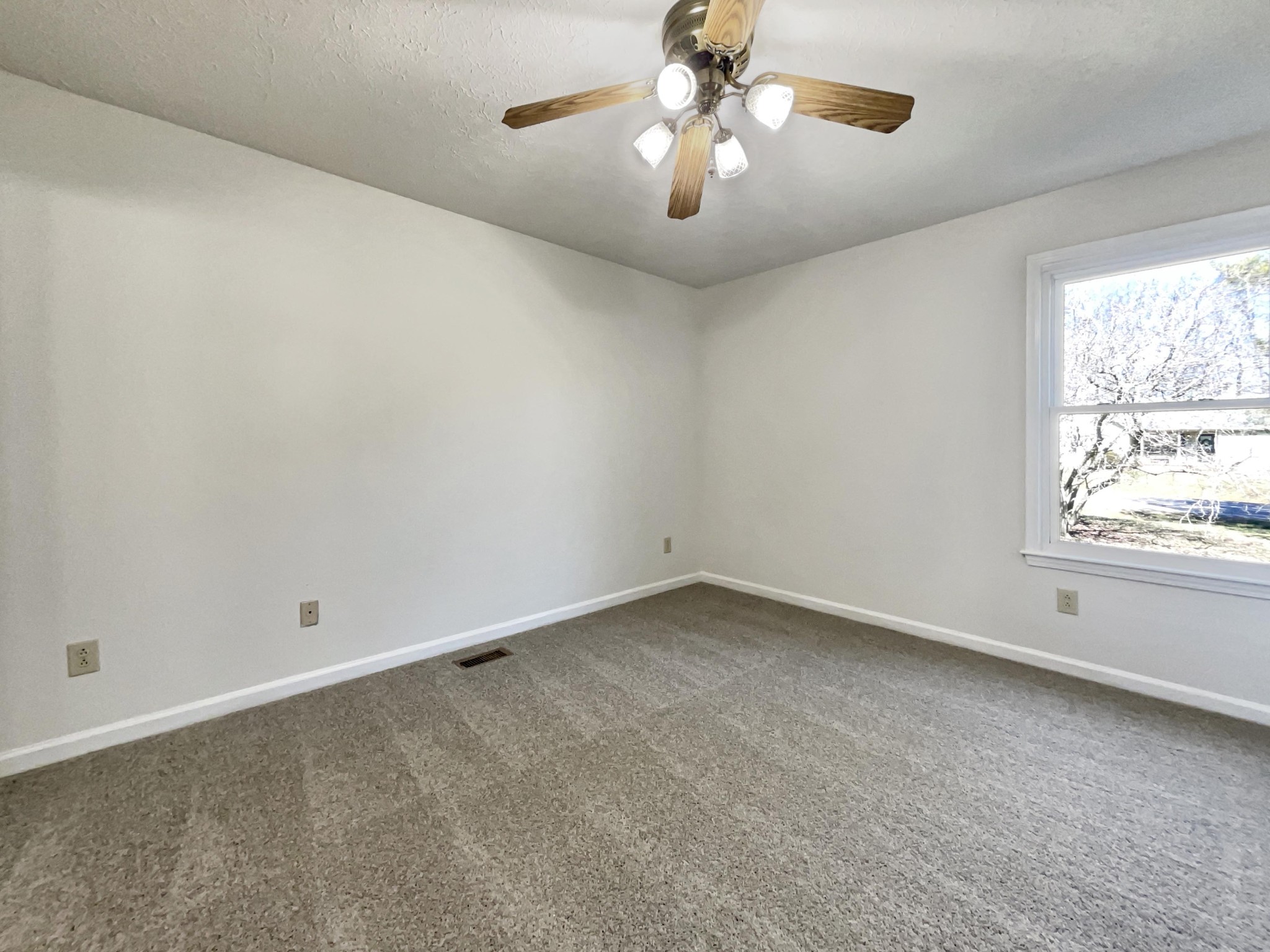 403 Canaan Road Columbia, TN 38401 - Photo 15 of 23 an empty room with a window and a ceiling fan