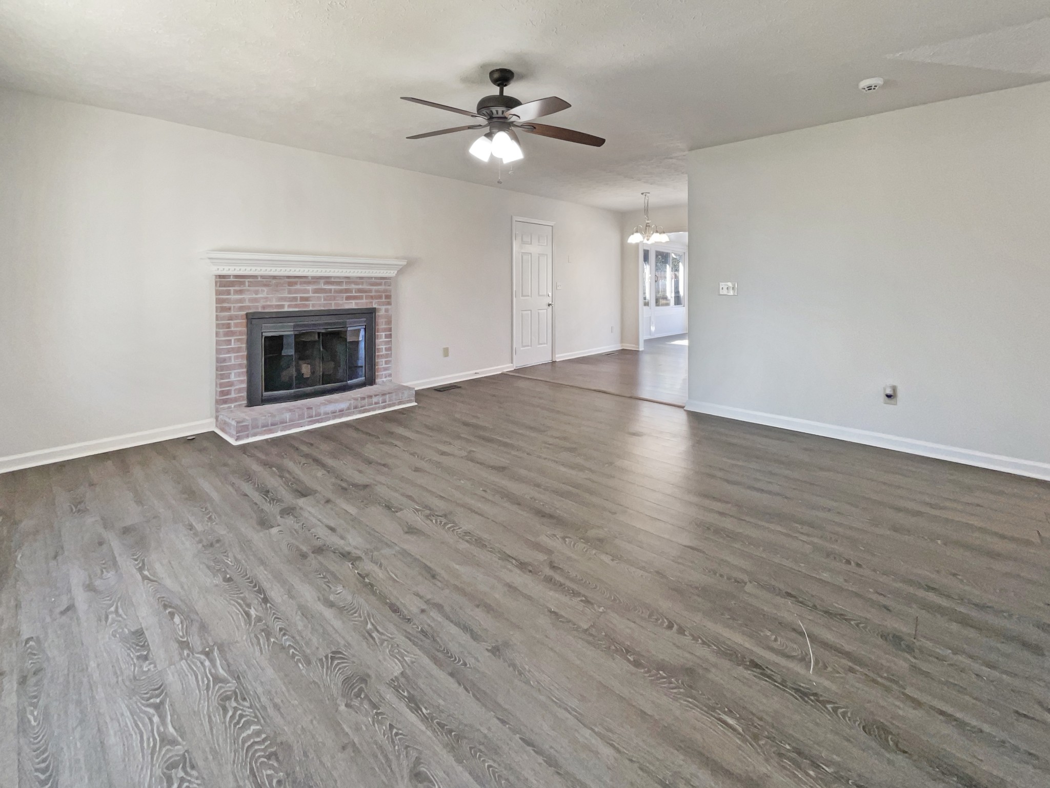 403 Canaan Road Columbia, TN 38401 - Photo 3 of 23 a view of an empty room with a fireplace and a chandelier fan