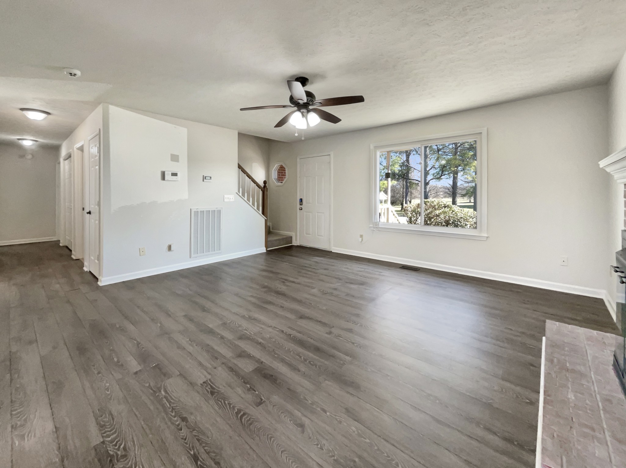 403 Canaan Road Columbia, TN 38401 - Photo 10 of 23 a view of an empty room with wooden floor and a ceiling fan