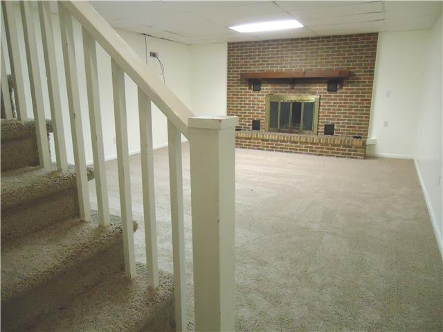 820 Hickory Ridge Trail Columbia, TN 38401 - Photo 15 of 20 Cozy basement with wood burning fireplace.. New carpet on steps leading to basement and basement living space. There is tons of extra storage down here as well as a full bathroom!!!