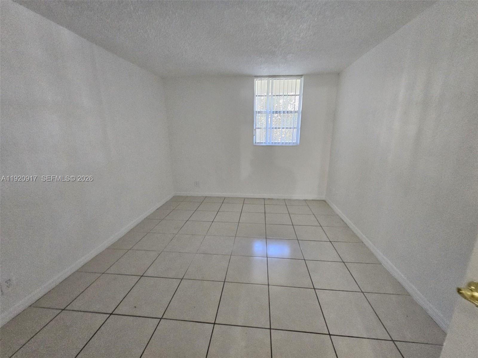 4550 Northwest 9th Street, Unit 217E Miami, FL 33126 - Photo 12 of 14 a view of an empty room and window