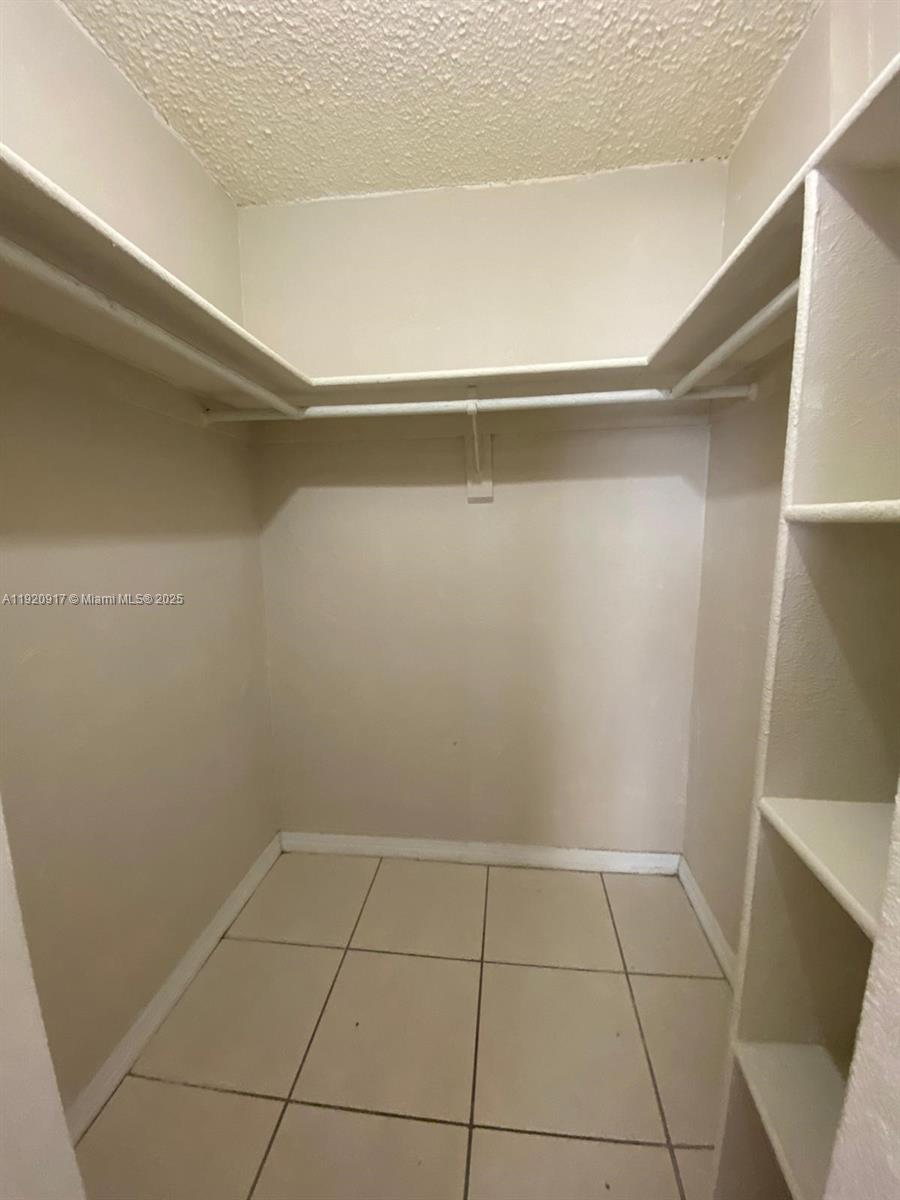 4550 Northwest 9th Street, Unit 217E Miami, FL 33126 - Photo 12 of 14 a view of an empty walk in closet