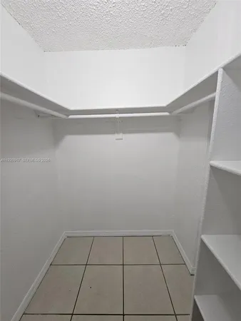 a view of walk in closet with clothes
