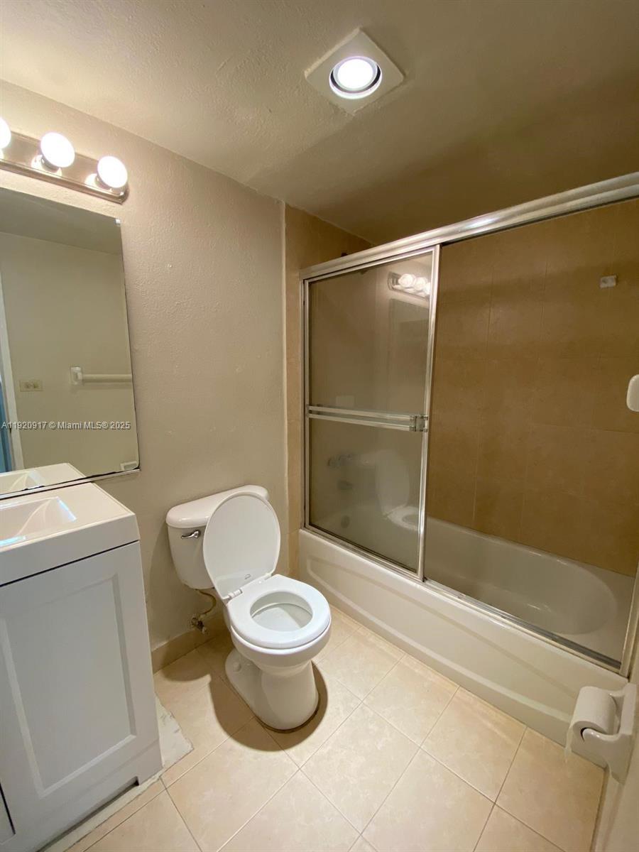 4550 Northwest 9th Street, Unit 217E Miami, FL 33126 - Photo 13 of 14 a bathroom with a toilet and a shower