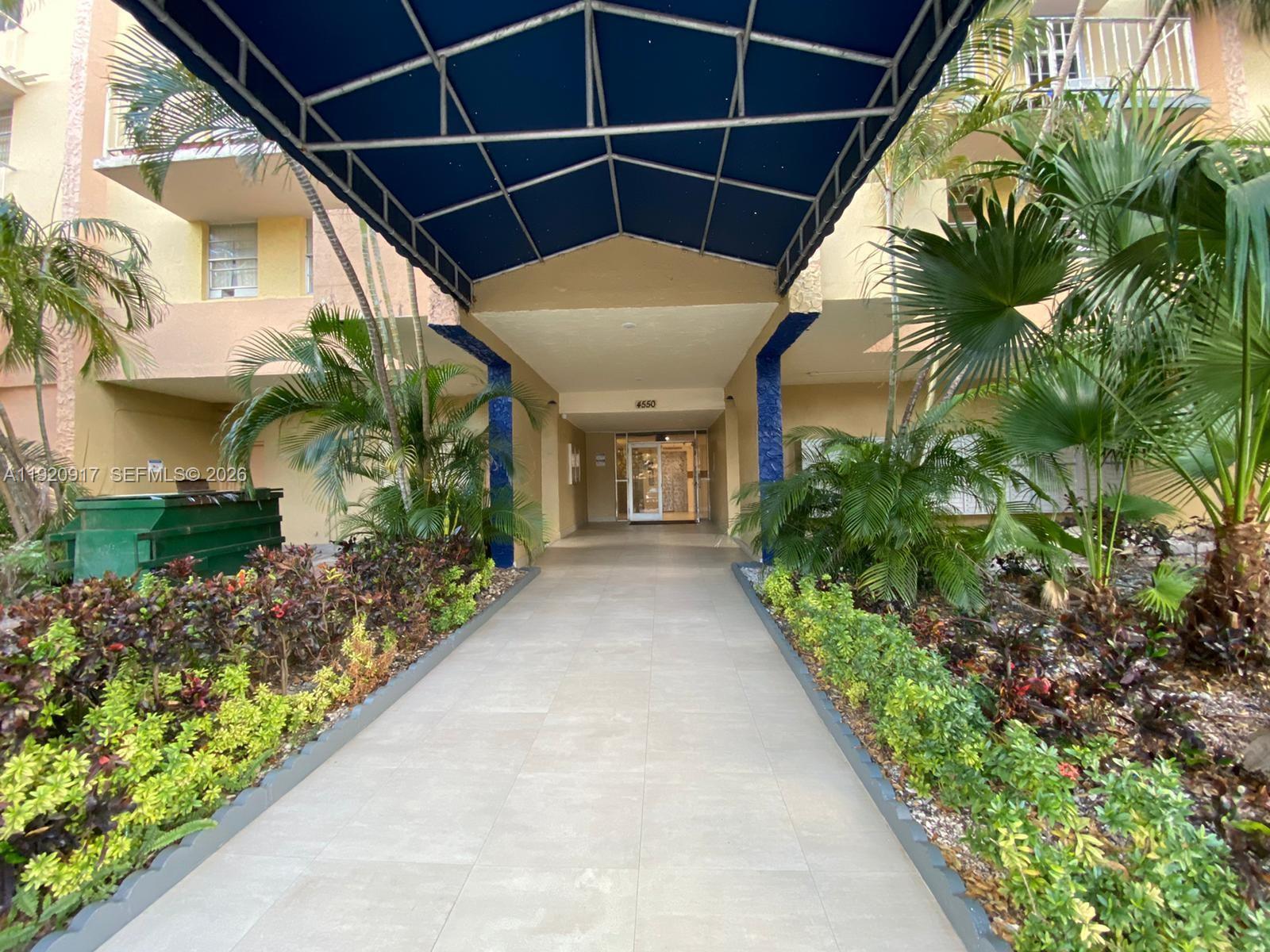 4550 Northwest 9th Street, Unit 217E Miami, FL 33126 - Photo 2 of 14 a view of a pathway of a house