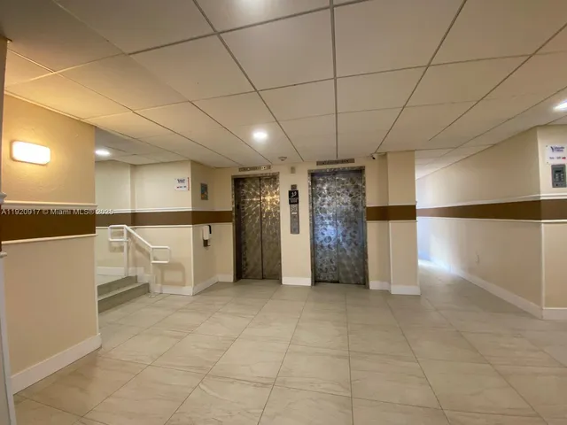 a view of a refrigerator in kitchen and utility room