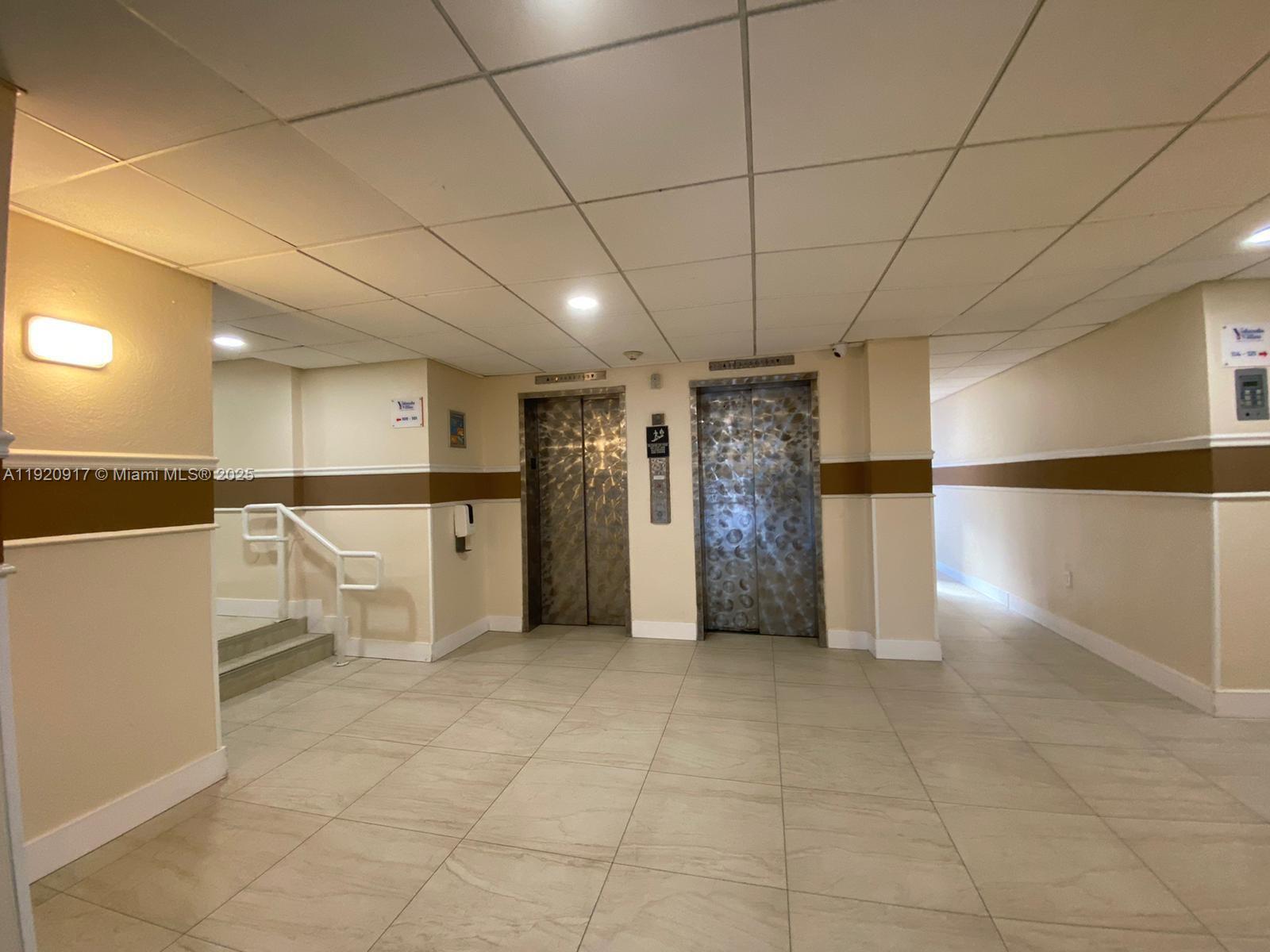 4550 Northwest 9th Street, Unit 217E Miami, FL 33126 - Photo 3 of 14 a view of a refrigerator in kitchen and utility room