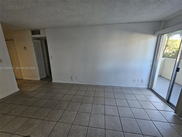 a view of an empty room and a window