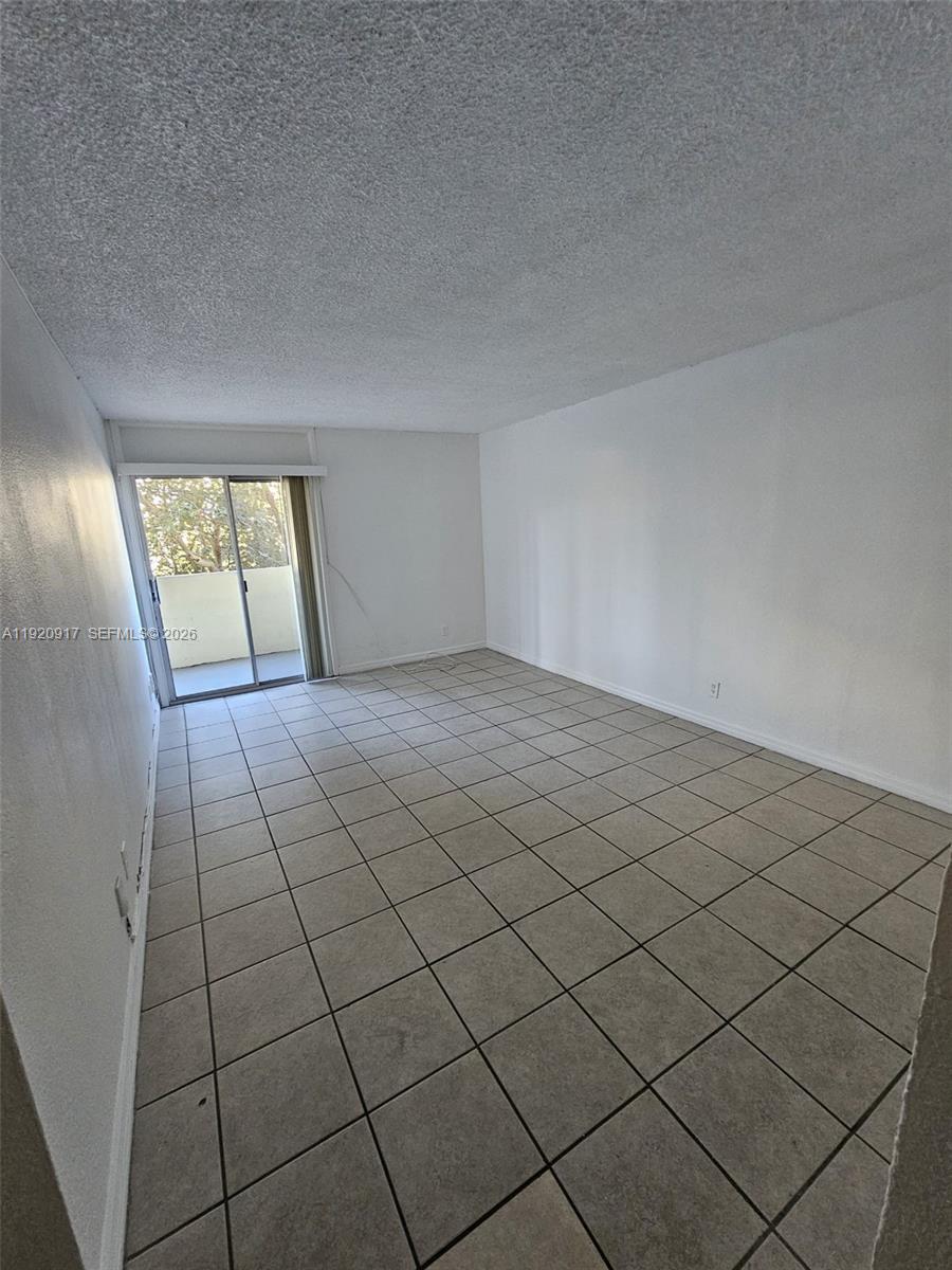 4550 Northwest 9th Street, Unit 217E Miami, FL 33126 - Photo 6 of 14 a view of an empty room and window