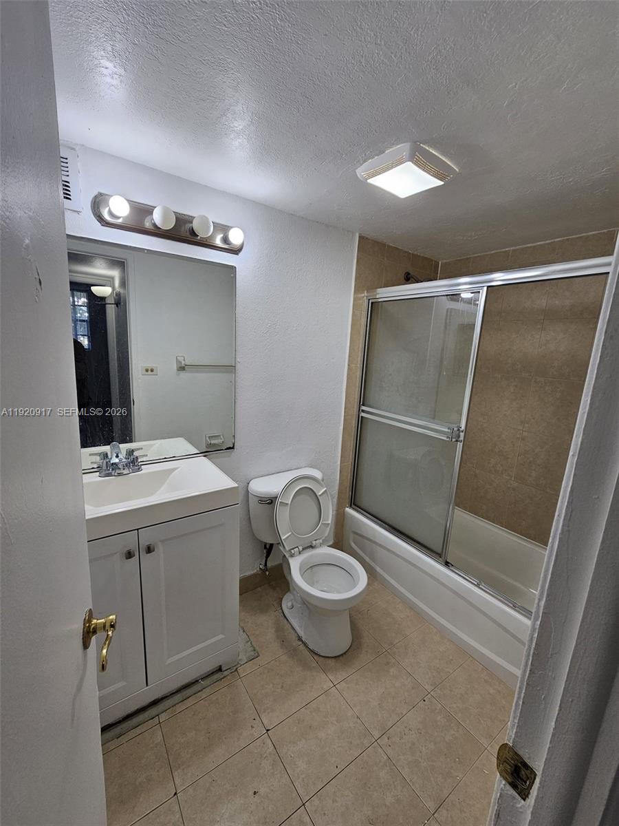 4550 Northwest 9th Street, Unit 217E Miami, FL 33126 - Photo 10 of 14 a bathroom with a sink toilet and shower