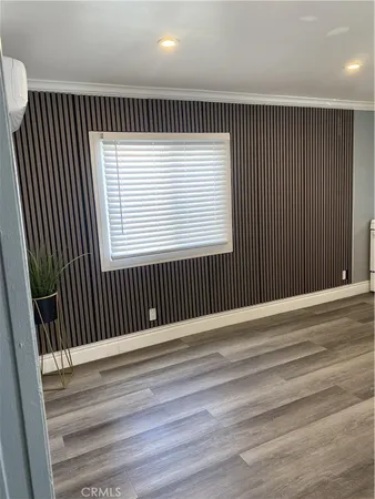 an empty room with wooden floor