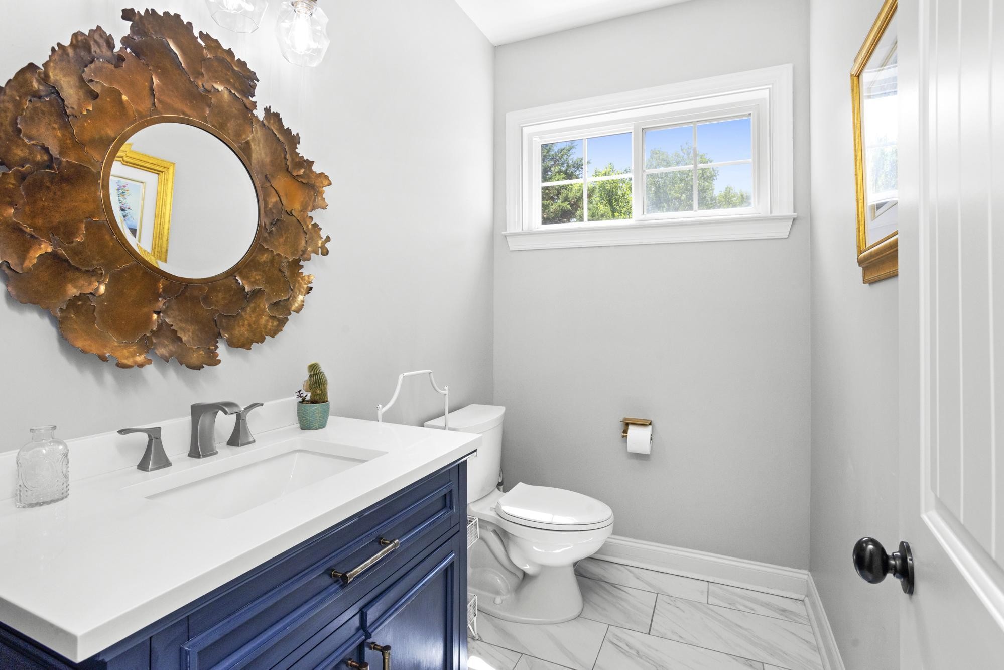 108 Hunters Run Nashville, TN 37209 - Photo 18 of 36 a bathroom with a toilet a sink and mirror