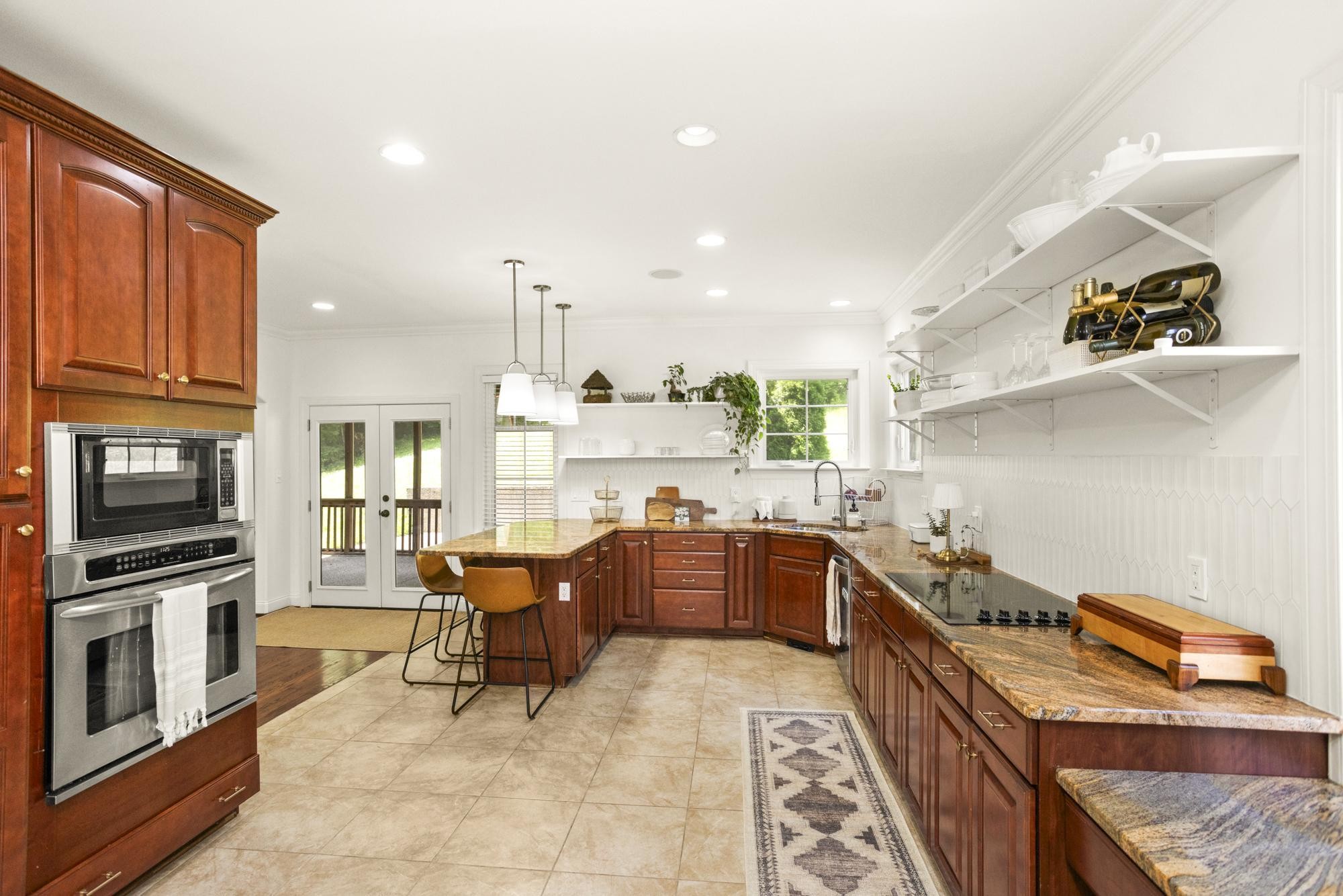 108 Hunters Run Nashville, TN 37209 - Photo 10 of 36 a kitchen with stainless steel appliances granite countertop wooden cabinets a sink dishwasher a stove and a refrigerator with wooden floor