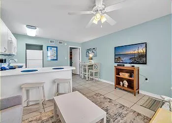 a kitchen with sink a refrigerator and cabinets