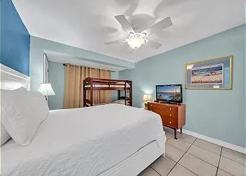 a bedroom with a large bed and a chandelier