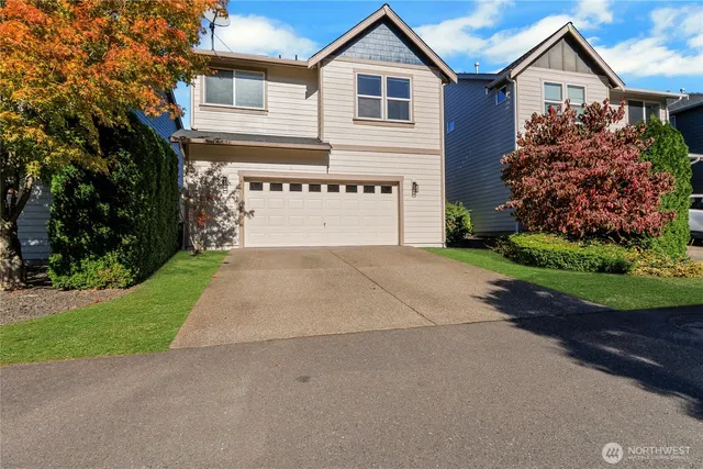 a front view of a house with a yard and garage