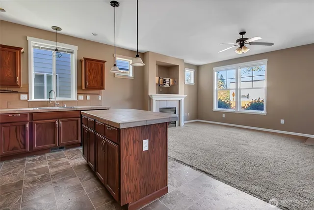 a kitchen with stainless steel appliances granite countertop a sink and a stove